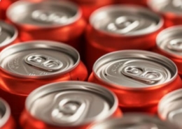 rows vibrant red soda cans focus texture repetition
