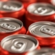 rows vibrant red soda cans focus texture repetition