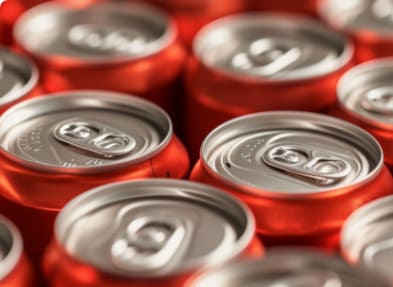 rows vibrant red soda cans focus texture repetition